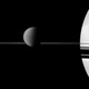 Illustration for article titled The moon Titan rests on Saturns razor-thin rings
